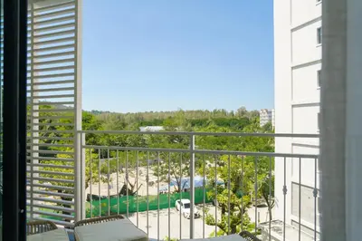 a balcony with a view of a beach and trees at Title Halo Lemon Sky Naiyang Gym Pool Hammam in Ban Bo Han