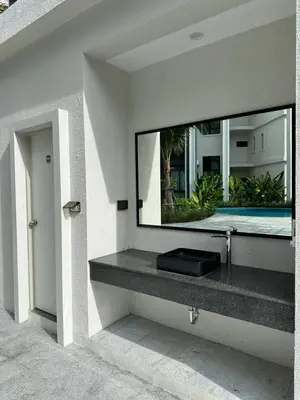 a mirror on the wall of a bathroom with a sink at Title Halo Lemon Sky Naiyang Gym Pool Hammam in Ban Bo Han