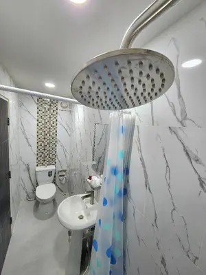 a bathroom with a white toilet and a sink at Raya villa in Ban Muang Mai