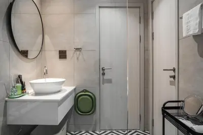 a bathroom with a sink and a shower with a mirror at Title Halo Pinky Lime Naiyang Pool Gym Hammam in Ban Bo Han