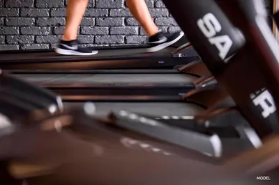 a person walking down stairs on a treadmill at Hotel Riu Palace Phuket - All Inclusive in Mai Khao Beach