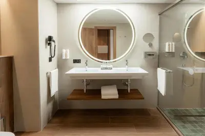 a bathroom with a sink and a mirror at Hotel Riu Palace Phuket - All Inclusive in Mai Khao Beach