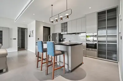 a kitchen with a bar with blue chairs at C32 Clover Residence Villa Phuket 3 bd in Ban Thalat Choeng Thale