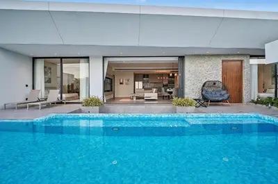 a large swimming pool in a house with a living room at C32 Clover Residence Villa Phuket 3 bd in Ban Thalat Choeng Thale