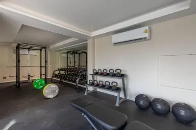 a room with a gym with a bunch of weights at 6-Bedroom Private Luxury Pool Villa in Layan in Thalang