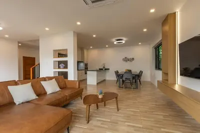 a living room with a couch and a table at Modern and Peaceful 3Bedroom Villa Family Retreat Rawai in Ban Saiyuan (1)