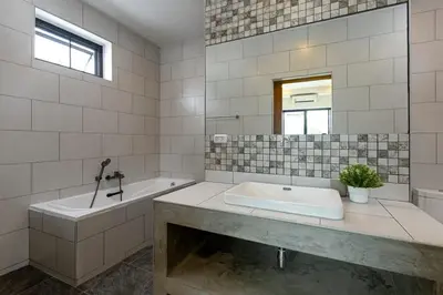 a white bathroom with a tub and a sink at Modern and Peaceful 3Bedroom Villa Family Retreat Rawai in Ban Saiyuan (1)