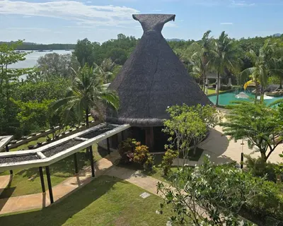 an aerial view of a resort with a thatch roof at BB Luxury Villa in Phuket Town