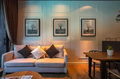 a living room with a couch and a table at Saturdays Residence by Sure in Ban Saiyuan (1)