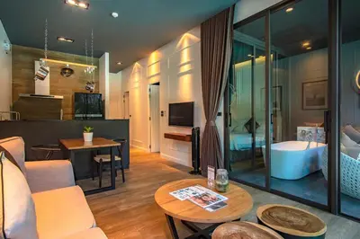 a living room with a couch and a tub in a room at Saturdays Residence by Sure in Ban Saiyuan (1)