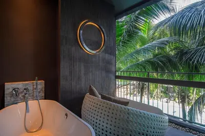 a bathroom with a tub and a large window at Saturdays Residence by Sure in Ban Saiyuan (1)