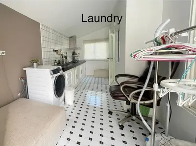 a laundry room with a washer and dryer in a kitchen at Spacious Modern Home & Garden Perfect for Families in Ban Na Nai