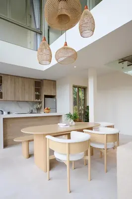 a kitchen with wooden tables and chairs and pendant lights at New Cozy 3BR Pool Villa Best Location- Boat Avenue in Ban Thalat Choeng Thale