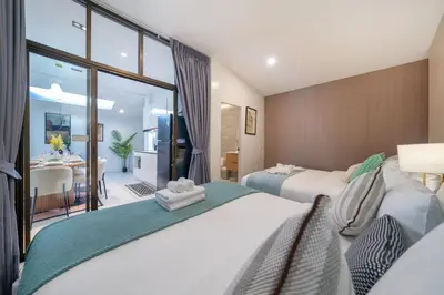 a bedroom with two beds and a dining room at Heart Patong pool villa with 5bedrooms in Patong Beach