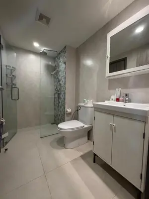 a bathroom with a toilet and a sink and a shower at 1 BDR 5 Swimming Pool Entire Apt Complex 5 Mins WALK To Naiyang Beach in Phuket
