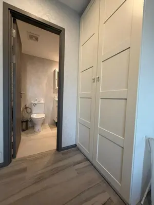 a bathroom with a door leading to a toilet at 1 BDR 5 Swimming Pool Entire Apt Complex 5 Mins WALK To Naiyang Beach in Phuket