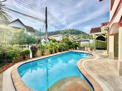 a swimming pool in front of a house at Phuket Villa - Private Pool in Ban Kathu
