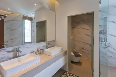 a bathroom with two sinks and a glass shower at Lux Nine Pasak by MonthstayZ Thailand in Ban Pak Lak