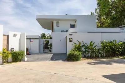 a white house with a driveway at Lux Nine Pasak by MonthstayZ Thailand in Ban Pak Lak