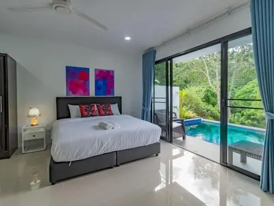 a bedroom with a bed and a swimming pool at Brand New Private pool villa Chalong Phuket Mountain view in Ban Klang