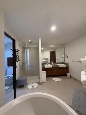 a bathroom with a tub and a shower and a sink at Dewa 1302 Poolside Resort Spacious 2 Bedroom in Phuket Town