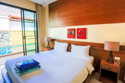 a bedroom with a large white bed and a window at 2 bedroom pool villa 250m TO Rawai beach A5 in Rawai Beach