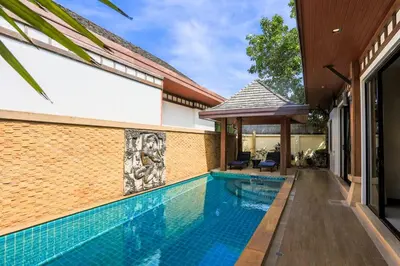 a swimming pool in the side of a house at 2 bedroom pool villa 250m TO Rawai beach A5 in Rawai Beach