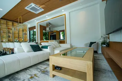 a living room with a white couch and a table at Andara Ao Nang Pool Villa in Ao Nang Beach