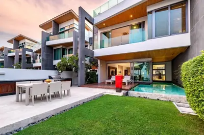an exterior view of a house with a swimming pool at Absolute Beachfront Villa 3-Bedroom in Rawai in Ban Saiyuan (1)