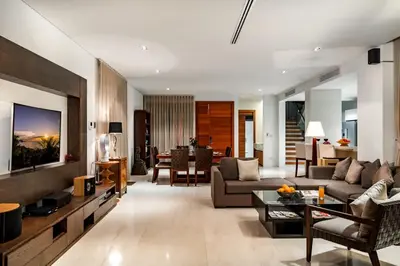 a living room with a couch and a table at Absolute Beachfront Villa 3-Bedroom in Rawai in Ban Saiyuan (1)