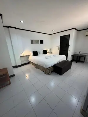 a large bedroom with a large bed in a room at Pathaya in Ban Kata