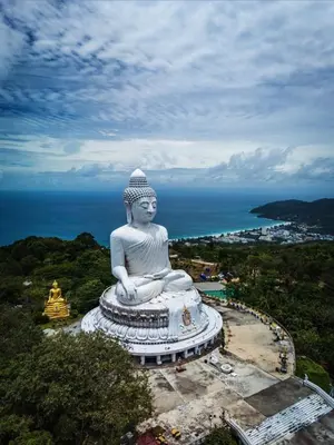 a large statue in front of the ocean at Pathaya in Ban Kata