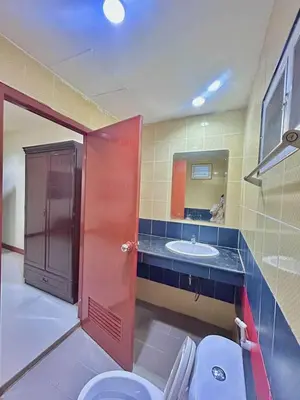 a bathroom with a toilet and a sink at Khan House Patong in Patong Beach