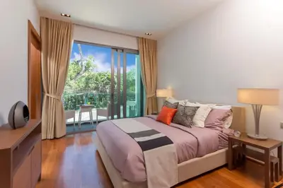 a bedroom with a bed and a large window at 4-Bed Villa-Sweeping Sunrise View over Chalong Bay in Ban Saiyuan (1)