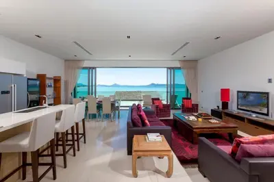 a living room with a couch and a table at 4-Bed Villa-Sweeping Sunrise View over Chalong Bay in Ban Saiyuan (1)