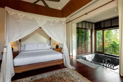 a bedroom with a canopy bed and a bath tub at Villa Barron - Spacious Luxury Family Holiday Home in Chalong