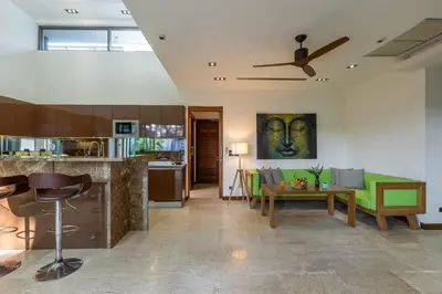 a kitchen and living room with green furniture at Diamond Tree Escape Pool Villa in Bangtao in Ban Pak Lak