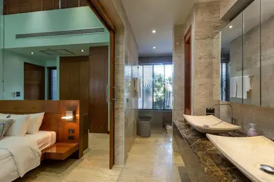 a bedroom with a bed and a tub and a sink at Diamond Tree Escape Pool Villa in Bangtao in Ban Pak Lak