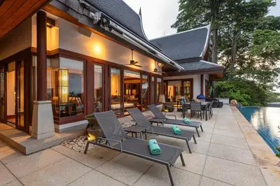 a patio with lounge chairs and a swimming pool at Villa Elan Luxury Surin Villa Panoramic Sea Views in Surin Beach