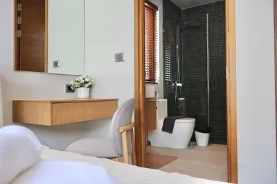 a bedroom with a bathroom with a toilet and a shower at Botanica - Bali Style Luxury 3 BR Private Pool Villa in Ban Pak Lak