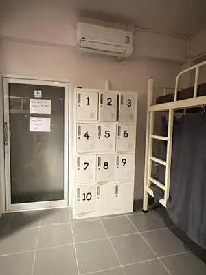 a room with a bunk bed and a door with numbers on it at Phi Phi Green House & Sunsky Hostel in Phi Phi Don