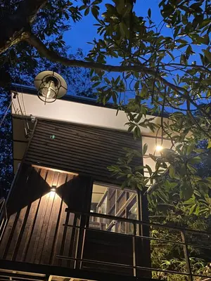 a building with a window and a street light at Kalm Cabin Phuket in Ban Phak Chit