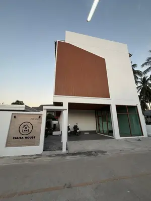 a building with a sign for a parking lot at Falisa House Apartment Bangtao in Ban Thalat Choeng Thale