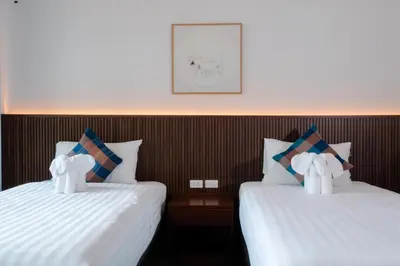 two beds with stuffed animals on them in a room at Oh'tel Kata in Kata Beach