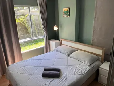 a bedroom with a bed with a large window at D Condo Kathu Monthly Stay Near Patong 30 Day Minimum in Kathu