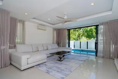 a living room with a couch and a table at Friendly Lux 5 Bedroom Villa Laguna park in Laguna Phuket