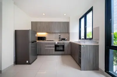 a kitchen with stainless steel appliances and a window at Friendly Lux 5 Bedroom Villa Laguna park in Laguna Phuket