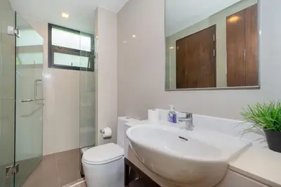 a bathroom with a sink and a toilet and a mirror at Luxury 5 bed Laguna Park no Pool in Laguna Phuket