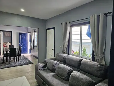 a living room with a couch and a dining room at Life & Beauty Villa 400m To Beach - Sleeps 7 in Ban Lum Fuang