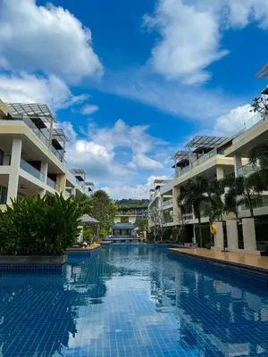 a swimming pool in front of some apartment buildings at The Pelican Residence & Suites Krabi in Ban Ko Kwang